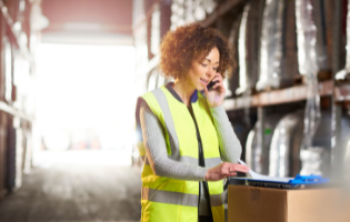 Woman Wearing a Safety Vest and on a Phone