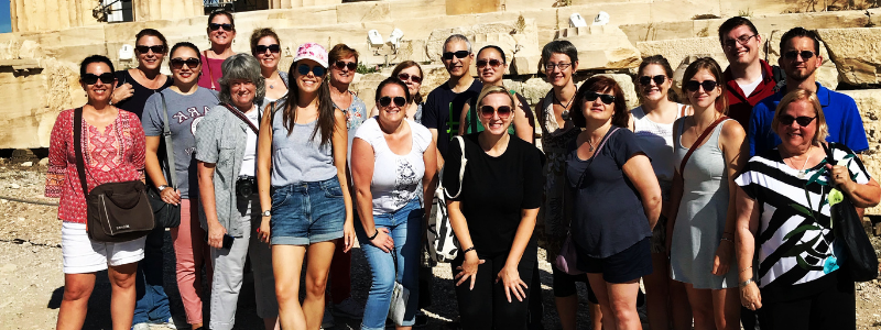 Group of People In Front of Greek Ruins