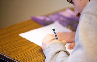 Woman Writing on Paper